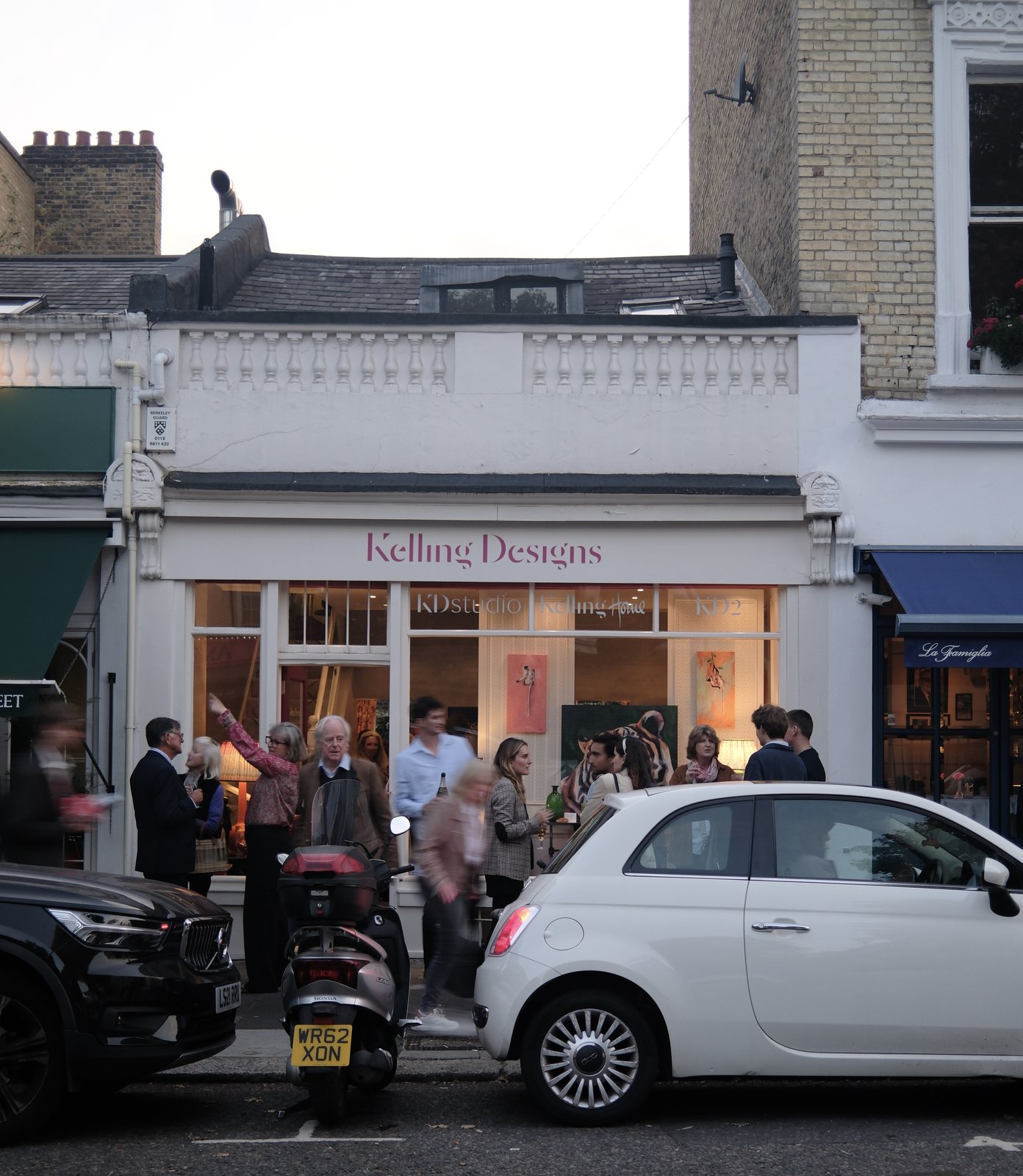 Opening night on the street outside Kelling Designs: the shopfront lit up with a crowd on the pavement